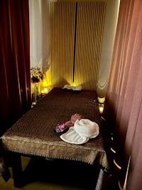 a bed in a room with candles on it