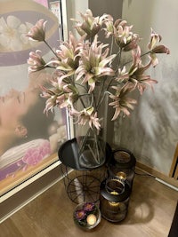 a vase of flowers sits on a table in front of a window